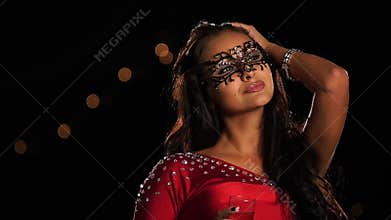 Beautiful brunette woman in a carnival mask on