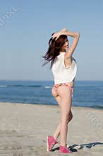 Slim young red hair woman wearing bottom bikini and shirt
