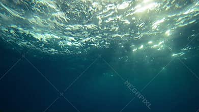 Beautiful underwater sea view with natural light rays in slow motion