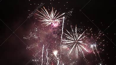Bright colorful fireworks on new years eve in Ostrava, Czech republic against cloudy sky