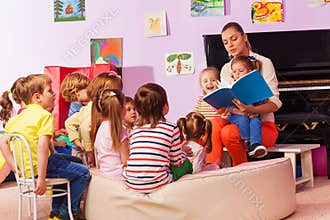 Nurse in kindergarten read book to the class