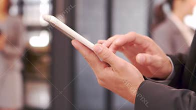 Cropped video of businessman typing on smartphone