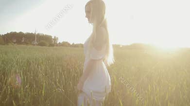 Beauty Girl running on green field in sunshine