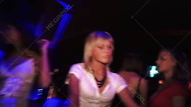 Girls in white dresses dancing at the club at the