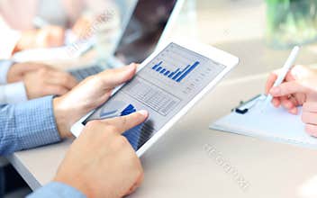 Group of businesspeople looking at graphs