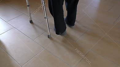 Disabled person walking with walker aid