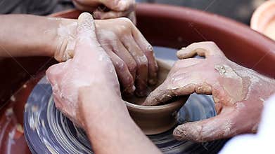An experienced potter craft teaches boys