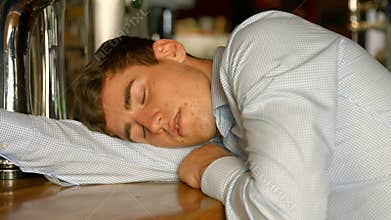 Drunk man sleeping at the bar