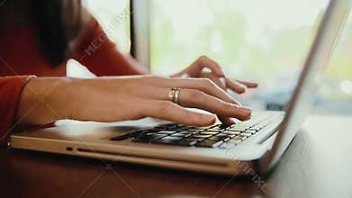 Woman working on laptop, computer in cafe. static