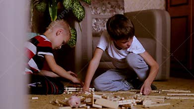 Two boys playing with toys is building a house