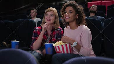 Woman eating popcorn and watching movie