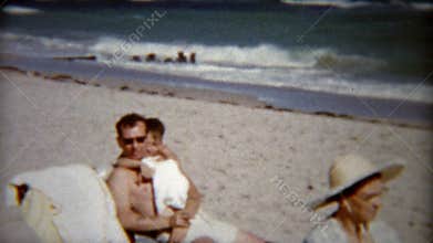1959: Kids playing with dad and gives stoic grandma some love. MIAMI, FLORIDA
