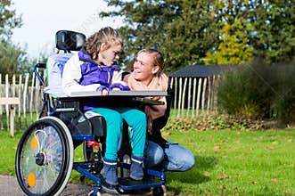 Disabled girl in a wheelchair relaxing outside