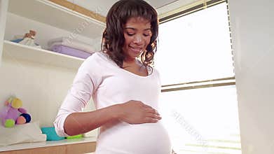 Pregnant woman looking at new cot
