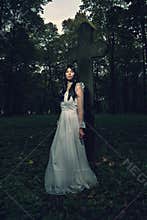 Witch from the cemetery, in front of cross