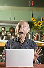 Shocked Senior Man with a Laptop Computer