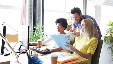 Happy creative team with computers in office