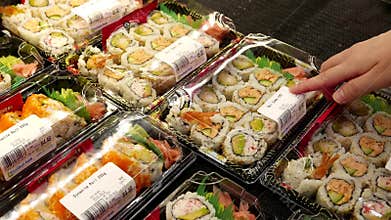 Woman buying sushi roll combo