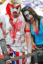 Rock star & crazy fan woman groupie zombies in famous annual Zombie Walk event Brisbane City, Australia