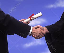 Graduation diploma and handshake