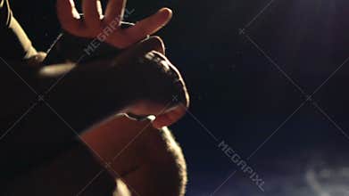 Boxer wrapping bandages on his hand before fight. Slow motion