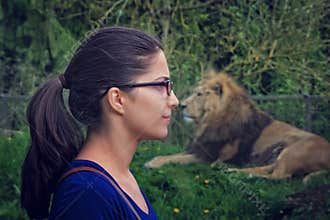Young woman facing a lion