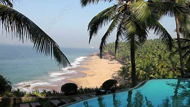 The pool on the edge of the rock overlooking the ocean and palm trees