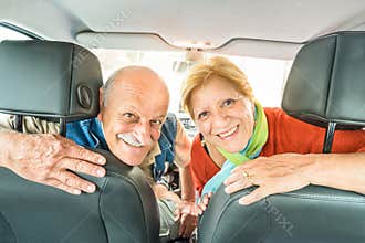 Happy senior retired couple ready for driving car on road trip