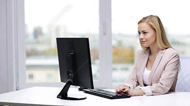 Young businesswoman with computer typing at office