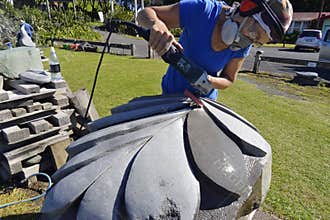 Artist stone sculptor carving sculpting huge New Zealand Silver Fern art piece
