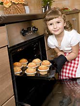 Little girl baking muffins