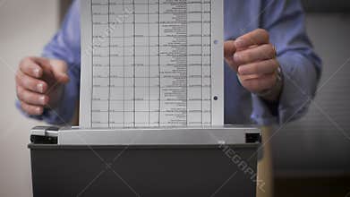 Close-up of male hands destroy documents. Female hands serving reports for destruction.