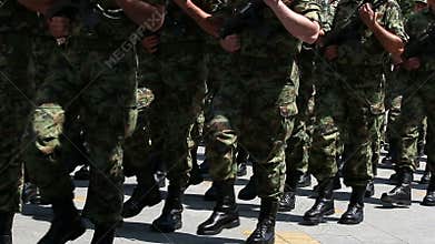 Soldiers marching with rifles