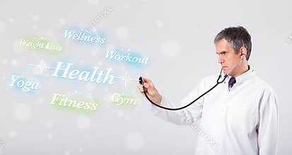 Clinical doctor pointing to health and fitness collection of words