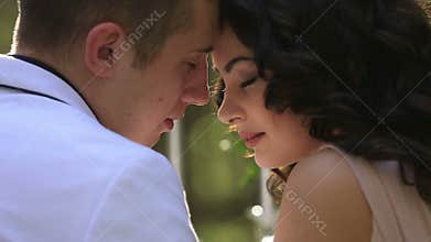 Tender moment of attractive young couple in love lovingly look at each other close up
