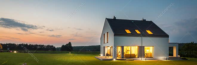 Modern house with garden at night