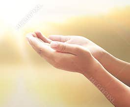 Cupped Hands Reaching Upward for Blessings in Soft Golden Ethereal Light