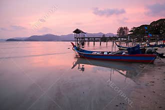 Sunrise by the beach with boat in George Town, Penang Malaysia