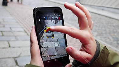 Pople playing Pokemon GO the hit augmented reality smart phone app
