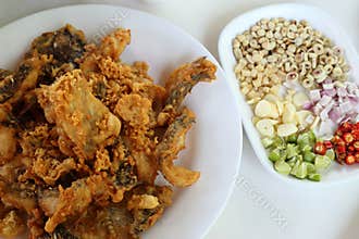 Complementing fish recipe - deep fried fish served with spices, vegetable and special sauce.