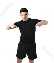 Attractive sport man pointing on his black t-shirt with copy space for adding gym fitness health club logo