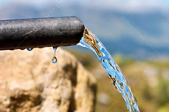 Pure water flowing n dropping from pipe
