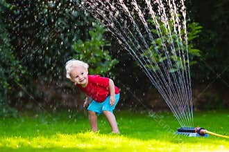 Kids playing with garden sprinkler