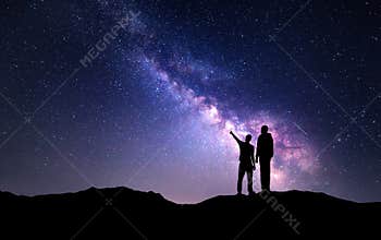 Landscape with Milky Way. Silhouette of a father and son