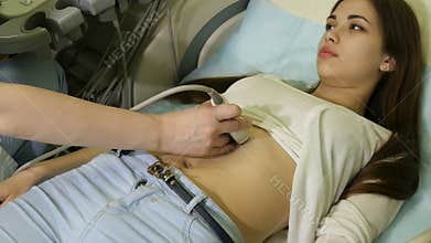 The doctor works with ultrasound device