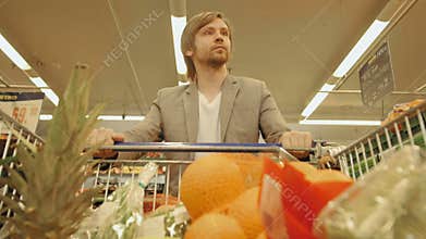 Handsome Man Shopping In A Supermarket, View From Shopping Trolley