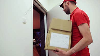 Happy man delivering parcel boxes to customer home