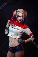 Cosplayer girl with in Harley Quinn costume. Halloween make up