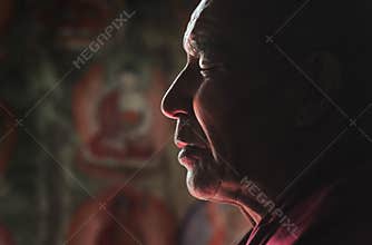 Ladakhi lama meditating with closed eyes