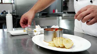 Chief-cooker prepares food on professional kitchen in restaurant, caviar with grilled vegetables with croutons